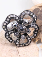 Decorative brooch with gemstones on a leaf background