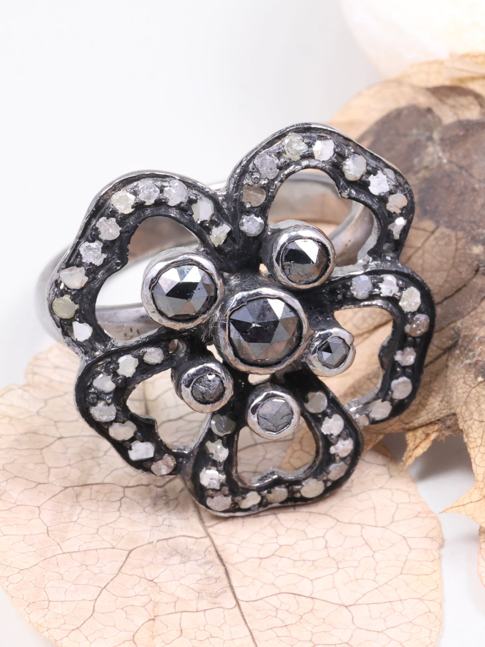 Decorative brooch with gemstones on a leaf