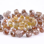 Fancy multi color raw natural diamond lot featuring yellow, brown and golden rough uncut stones