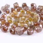 Fancy multi color raw natural diamond lot featuring yellow, brown and golden rough uncut stones