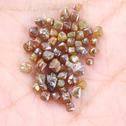 Fancy multi color raw natural diamond lot featuring yellow, brown and golden rough uncut stones