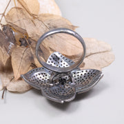 Vintage 4 Petal Pave wedding ring with emerald accents in an Art Deco sterling silver setting.