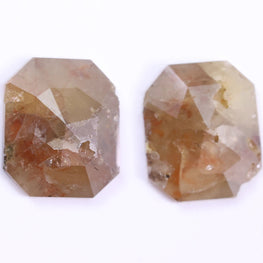 Two octagonal cut gemstones on a white background