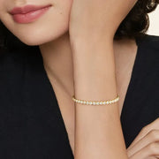 Tennis bracelet diamond jewelry with sparkling white diamonds in gold setting.