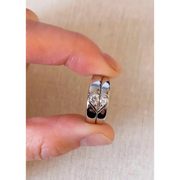 Romantic rose gold couple rings with intertwined hearts, symbol of unity.