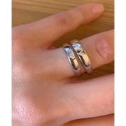 Romantic rose gold couple rings with intertwined hearts, symbol of unity.
