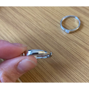 Romantic rose gold couple rings with intertwined hearts, symbol of unity.