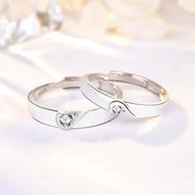 Romantic rose gold couple rings with intertwined hearts, symbol of unity.
