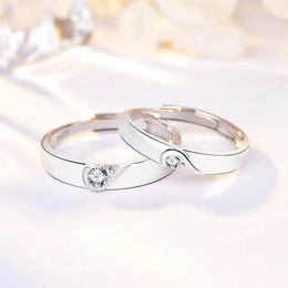 Romantic rose gold couple rings with intertwined hearts, symbol of unity.