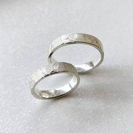 Infinity design couple rings symbolizing eternal love, crafted in sterling silver.