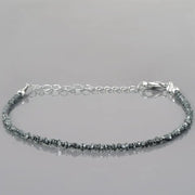 gold cuban bracelet and gold engraved bracelet paired with natural raw diamond bracelet 