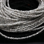 Collection of raw natural diamonds including a raw diamond, raw blue diamonds, grey diamond beads, raw diamond strand