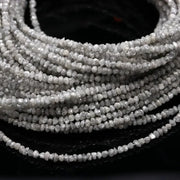 Collection of raw natural diamonds including a raw diamond, raw blue diamonds, grey diamond beads, raw diamond strand