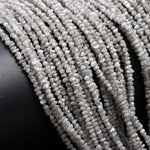 Collection of raw natural diamonds including a raw diamond, raw blue diamonds, grey diamond beads, raw diamond strand