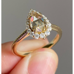pear cut yellow diamond ring with round diamond halo 