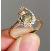 pear cut yellow diamond ring with round diamond halo 