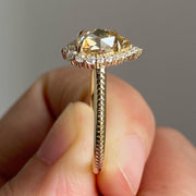 pear cut yellow diamond ring with round diamond halo 