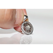Round halo pendant with lab grown diamond center and green gemstone accents in vintage design