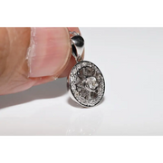 Round halo pendant with lab grown diamond center and green gemstone accents in vintage design