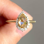 pear cut yellow diamond ring with round diamond halo 