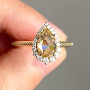 pear cut yellow diamond ring with round diamond halo 