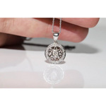 Round halo pendant with lab grown diamond center and green gemstone accents in vintage design