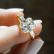cushion cut diamond ring with baguette side stones in yellow gold