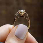 cushion cut diamond ring with baguette side stones in yellow gold