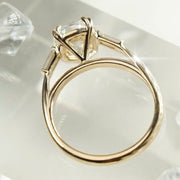 cushion cut diamond ring with baguette side stones in yellow gold