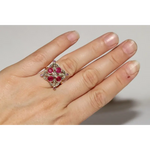 Lab created gemstone diamond ring with pink center stone and sparkling white diamonds in gold setting