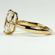 elongated cushion cut diamond ring with twisted yellow gold shank