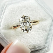 elongated cushion cut diamond ring with twisted yellow gold shank