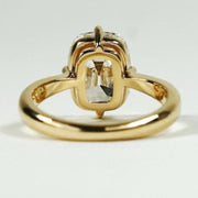 elongated cushion cut diamond ring with twisted yellow gold shank