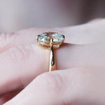 elongated cushion cut diamond ring with twisted yellow gold shank