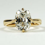 elongated cushion cut diamond ring with twisted yellow gold shank