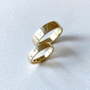 Rose gold couple rings with engraved initials, a romantic personalized gift idea.