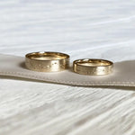 Rose gold couple rings with engraved initials, a romantic personalized gift idea.