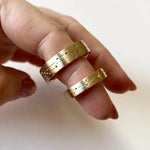 Rose gold couple rings with engraved initials, a romantic personalized gift idea.