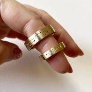 Rose gold couple rings with engraved initials, a romantic personalized gift idea.