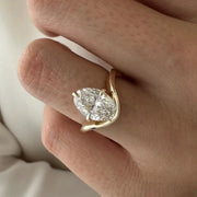 2 carat oval diamond three-stone ring set in white gold on a woman’s hand