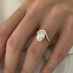 2 carat oval diamond three-stone ring set in white gold on a woman’s hand