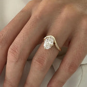 2 carat oval diamond three-stone ring set in white gold on a woman’s hand