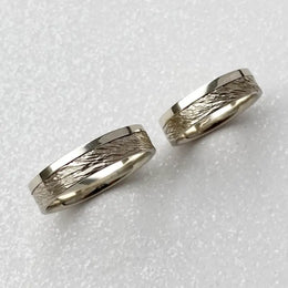 Minimalist sterling silver couple ring set, sleek design ideal for modern partners.