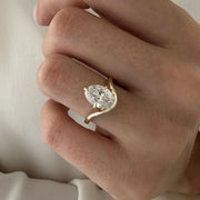 2 carat oval diamond three-stone ring set in white gold on a woman’s hand