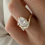 2 carat oval diamond three-stone ring set in white gold on a woman’s hand