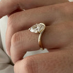 2 carat oval diamond three-stone ring set in white gold on a woman’s hand