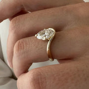 2 carat oval diamond three-stone ring set in white gold on a woman’s hand