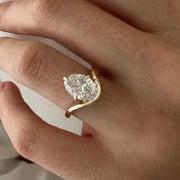 2 carat oval diamond three-stone ring set in white gold on a woman’s hand
