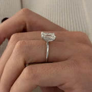 3 carat oval diamond three-stone ring set in polished white gold on a woman’s hand