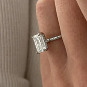 3 carat oval diamond three-stone ring set in polished white gold on a woman’s hand